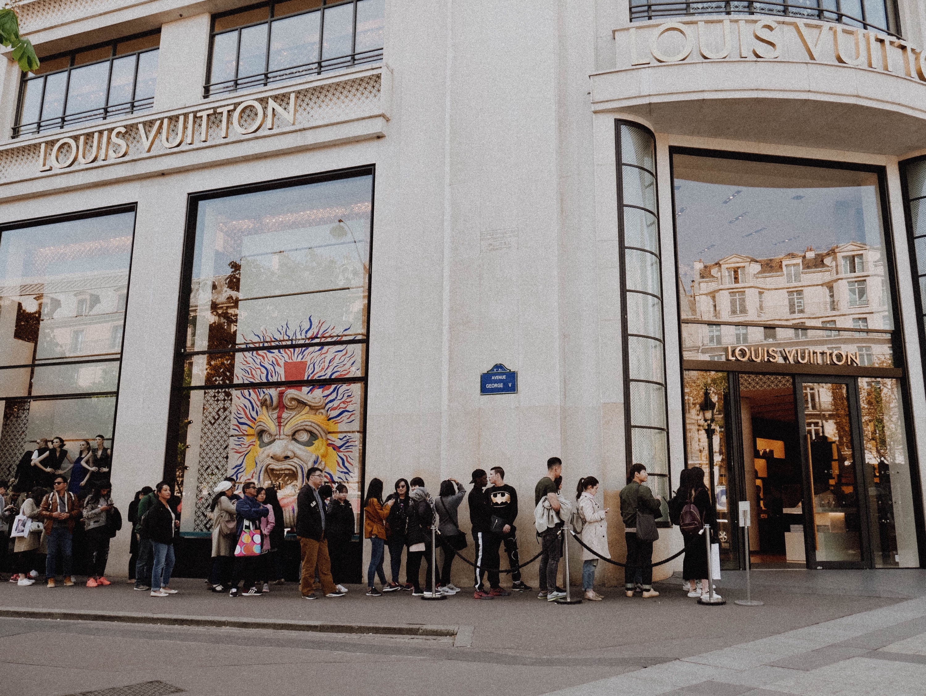 Queue outside of a store. Image via Unsplash.