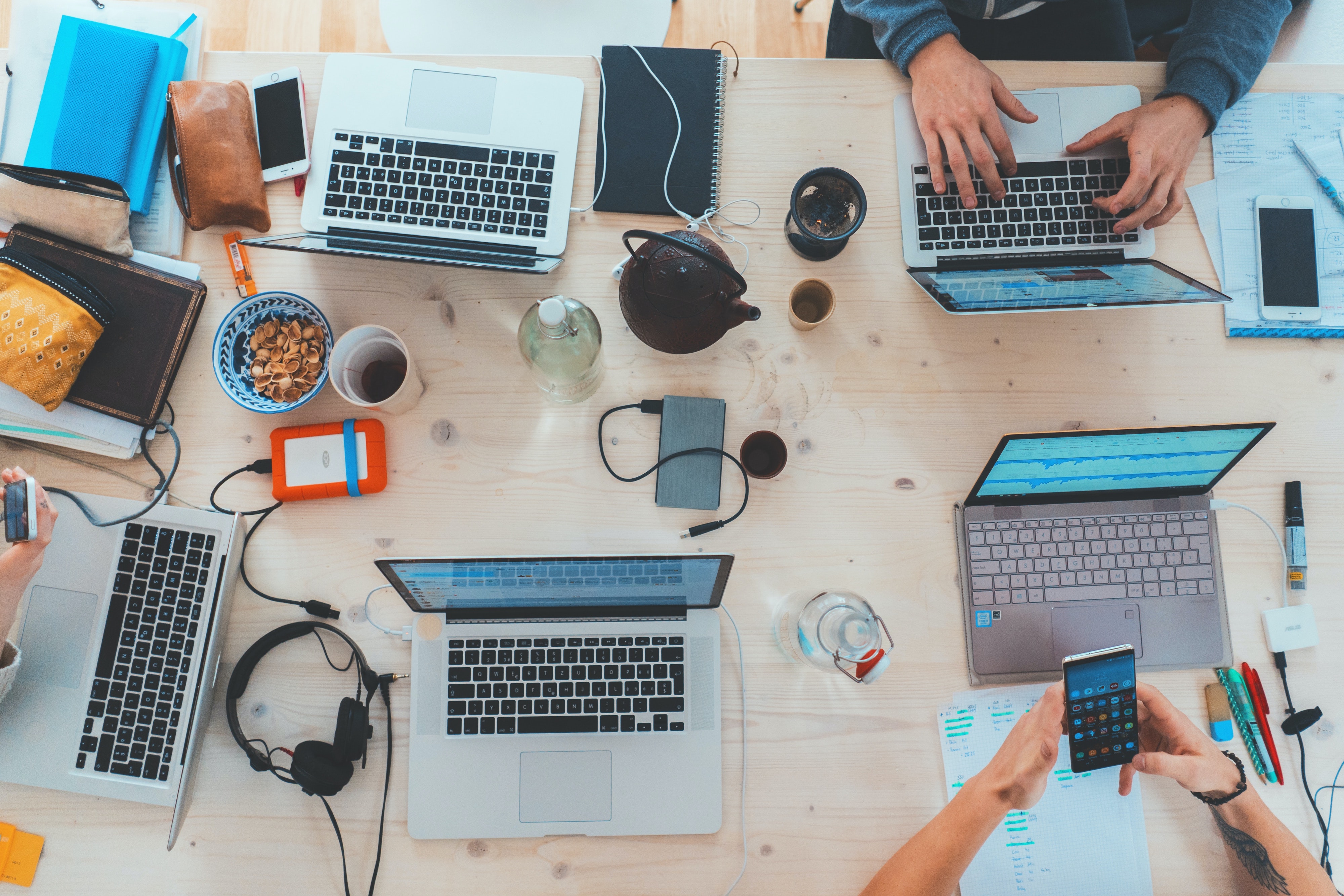 Group working at laptop computers. Image via Unsplash.