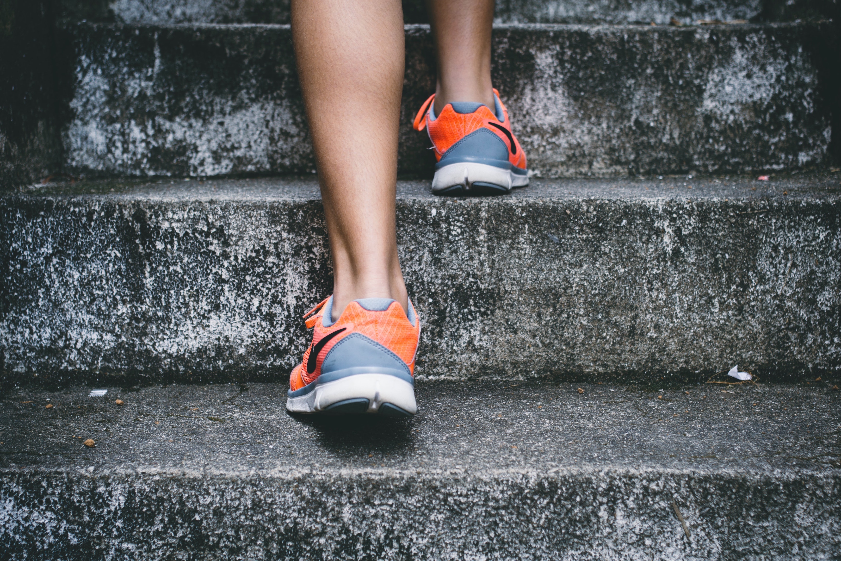 A person walking up steps. Image via Unsplash.